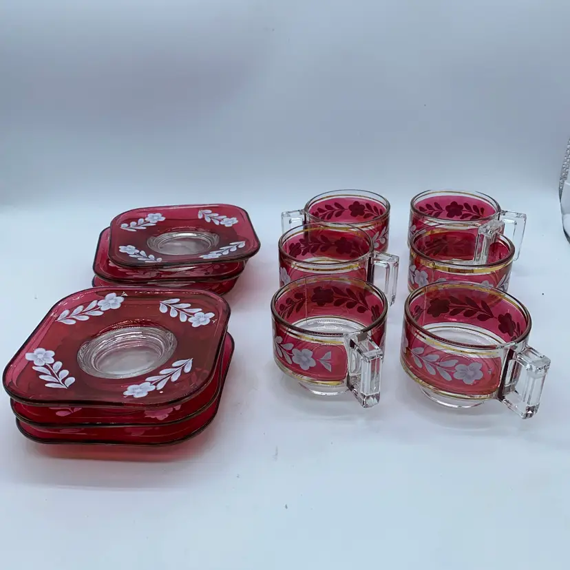 #1823 A set of six Joe Colombo designed ruby red glass cups and saucers with floral enamel.