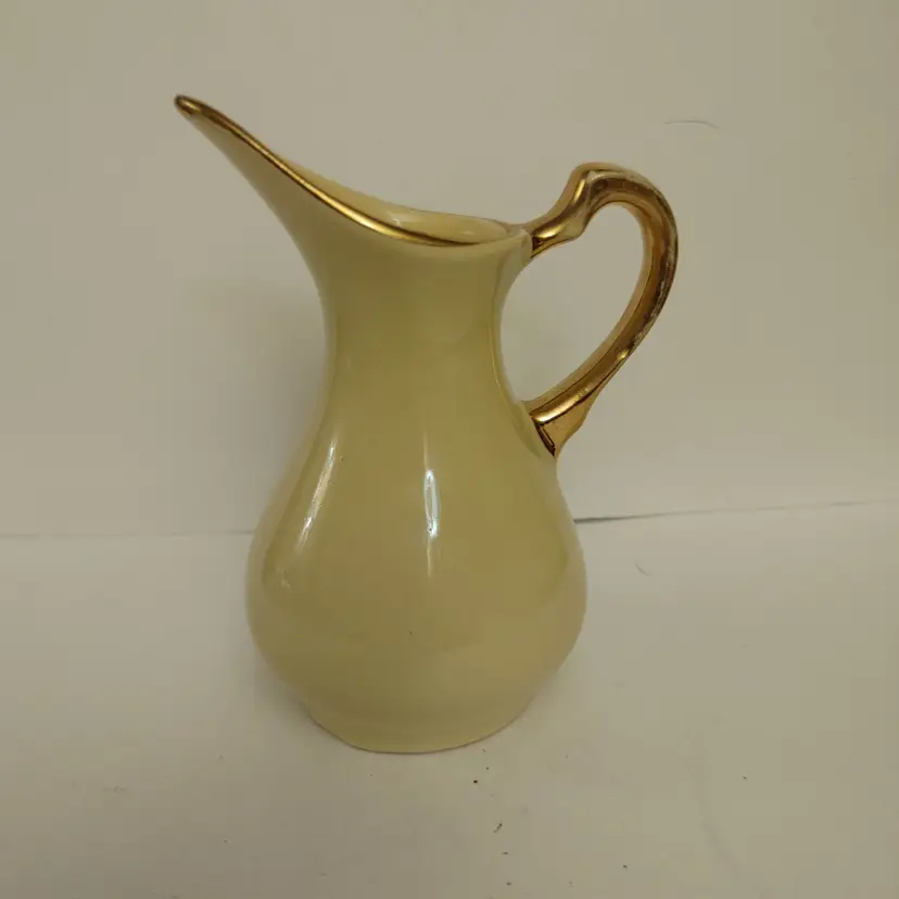 Yellow Ceramic Creamer with 22K Gold Handle. Usa. 4 inches high. No chips or cracks.