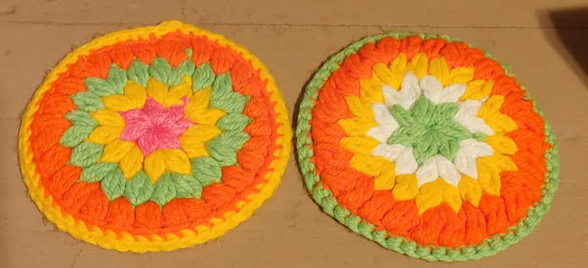 2 crochet hot pads- green yellow orange pink. 8 inch diameter.