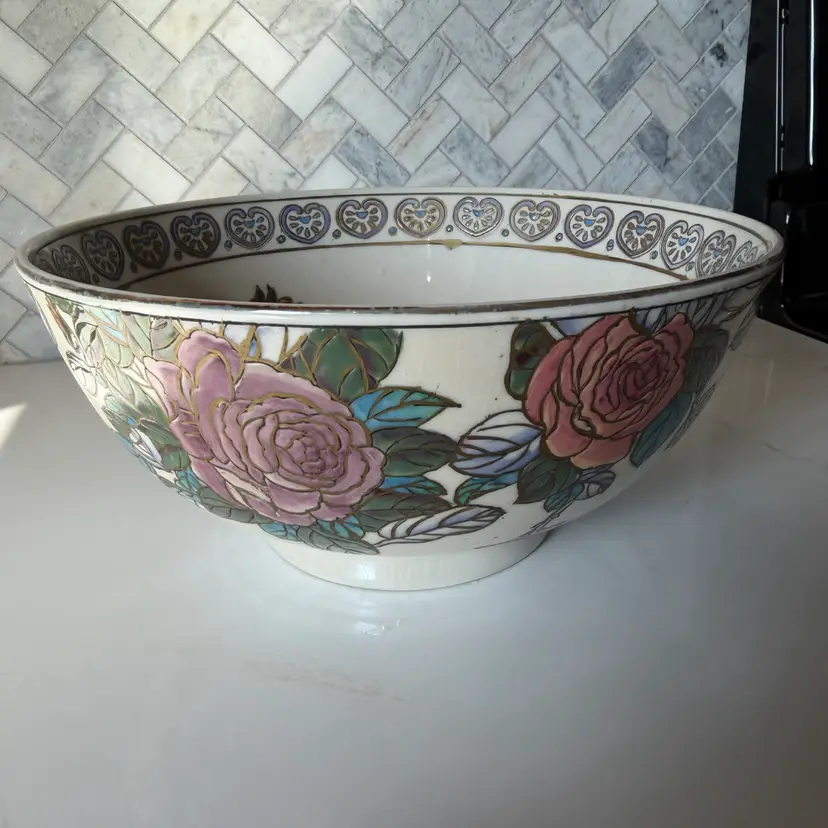 A vintage hand-painted porcelain fruit bowl by Toyo with floral motifs.
