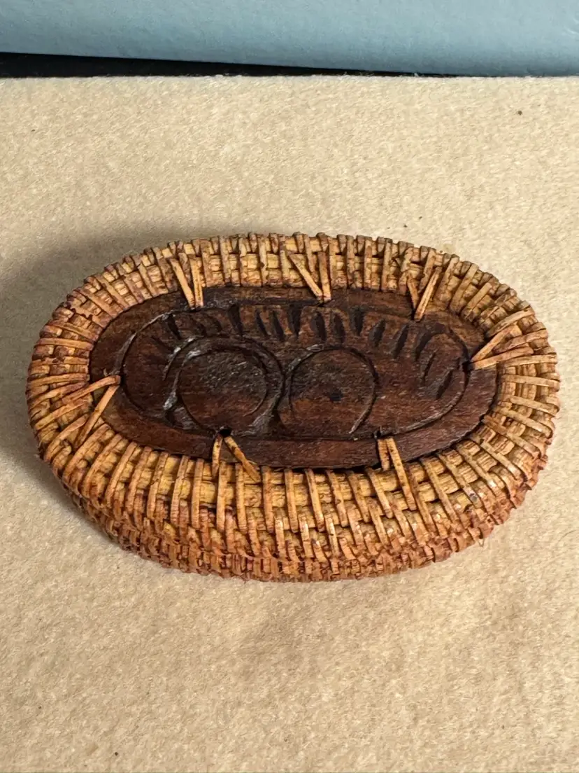 Hand-carved wooden lidded basket with woven fiber body