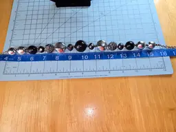 22 in necklace with large black, bronze, silver and faceted beads.