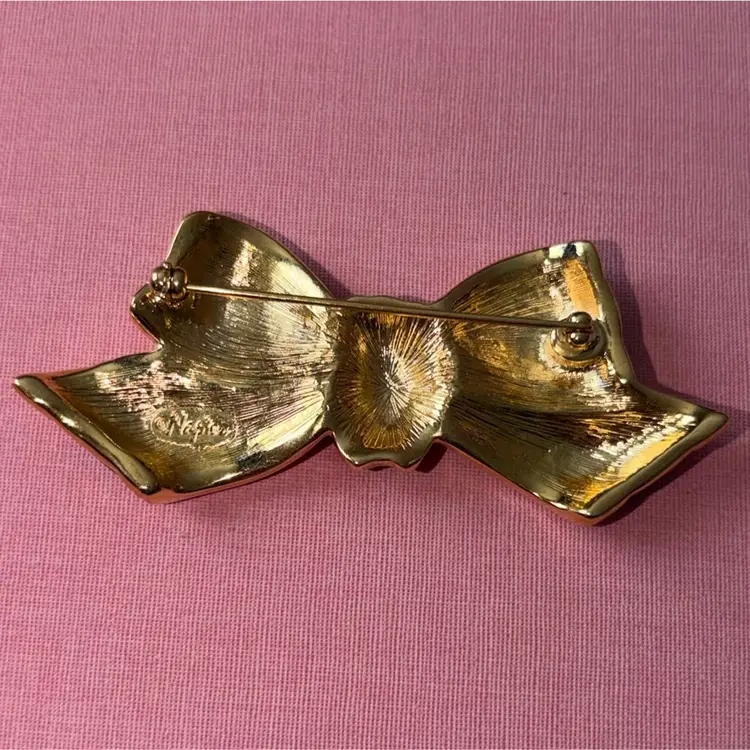 Napier Glossy Black Enamel, Clear Rhinestone And Gold Tone Metal Ribbon Bow Brooch