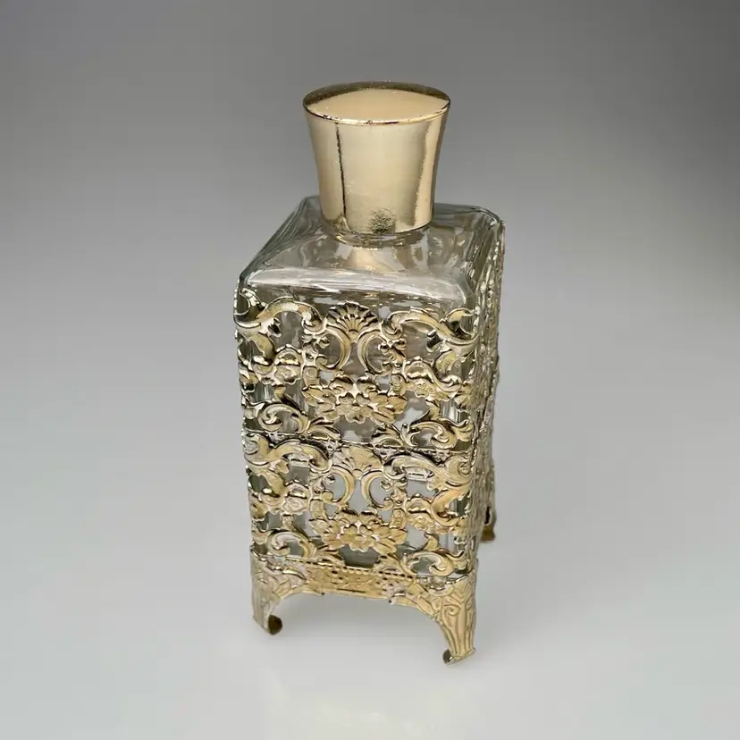 Gold Tone Metal Filigree Over Glass Footed Perfume Bottle Vintage Vanity Decor 5"