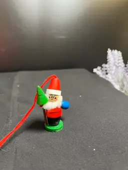 #01 Steinbach-West Germany-Santa Holding Tree and has a Blue Toy Bag Wood Ornament-Lot 60