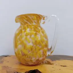 Hand blown yellow glass pitcher, white swirls, applied handle, artist signed