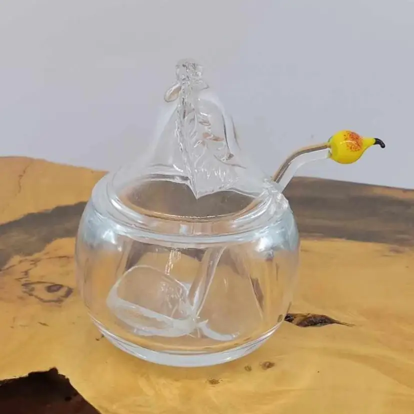 Glass pear shaped jar with glass pear topped spoon, jam, jelly