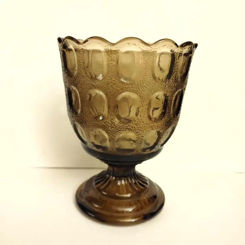 E.O. Brody brown Pedestal Vase. Model M4200. Thumbprint pattern. 4.5 inch diameter. 6 inches high. No chips or cracks.