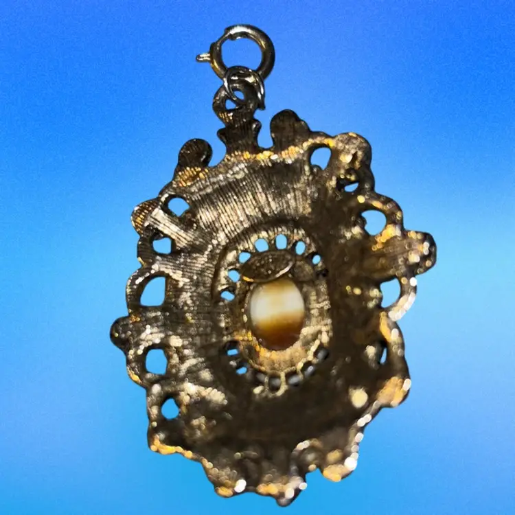 Celebrity NY Gold Tone Pendant Prong Set Center Brown Glass  Cabochon Set In Decorative Designed Edged With Smaller Dark Color Rhinestones