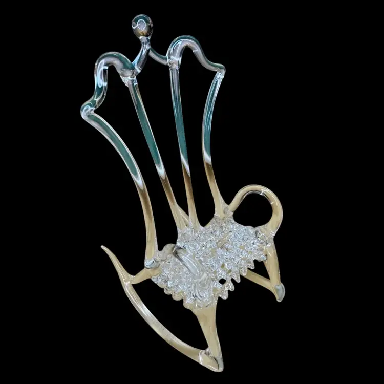Mini vintage hand-blown glass rocking chair figurine. It is a delicate, decorative object, often used as a collectible