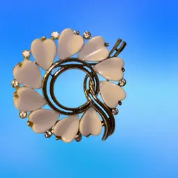 #01 Vintage Lisner Silver Tone Circular White Thermoset Heart Shaped Open Center With Tiny Rhinestones And Silver Tone Like Ribbon Running Thru Middle.
