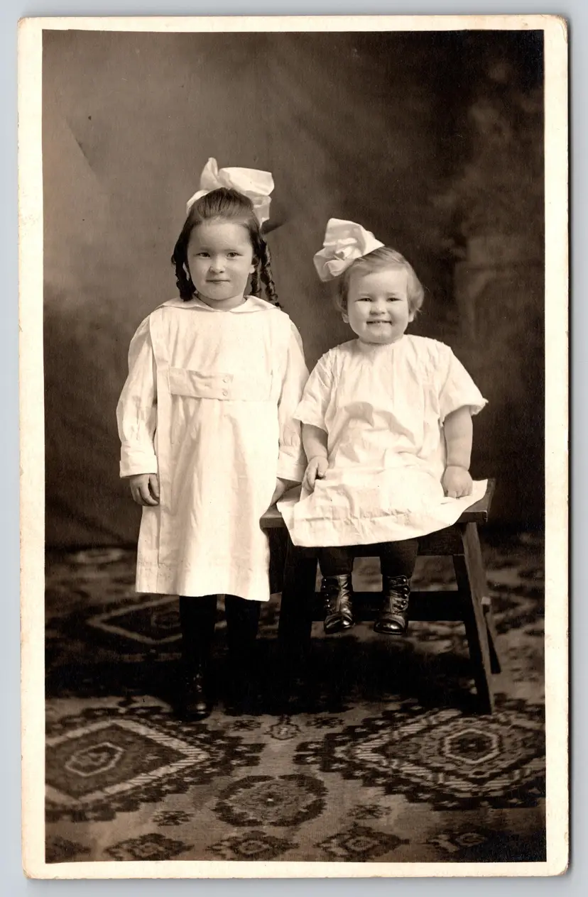 Postcard RPPC Siblings in White Sitting on Chair Sisters Real Photo Hair Bows  - 9083