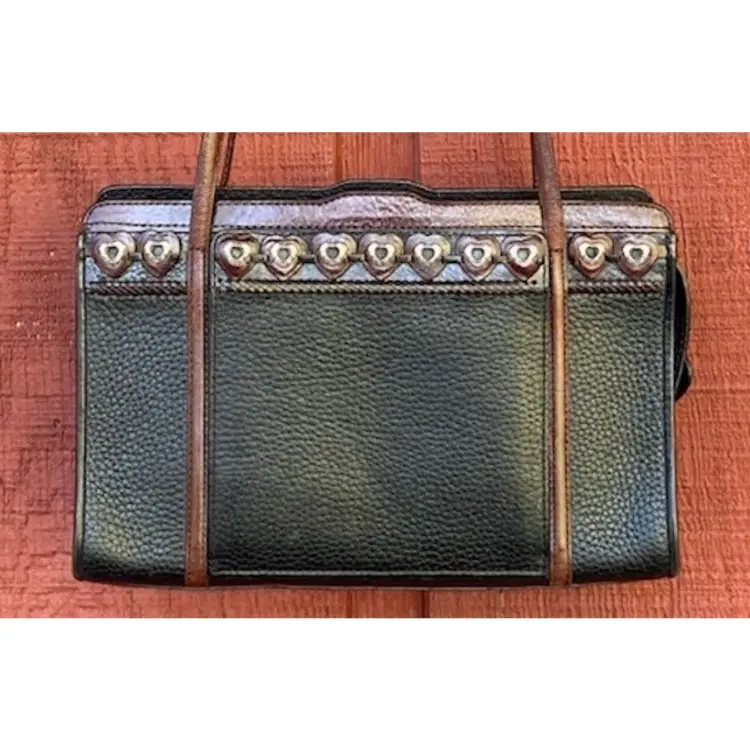 Brighton Purse / Bag C606859. Pebbled Black Leather With Brown Leather Straps. Motif Of Brown Leather Hearts With Metal Heart Accents. Zipper Has Black Leather Heart Pull. Three Interior Compartments, Which Include a Zipper Coin Pocket, Pen & Card Holders (?), and a Key Clip. Exterior Compartment Has Clear ID Or Card Holder, Plus Slots For 8 Additional Cards. 10”w x 6”h x 2.75”d (5.5” Opening at Top).