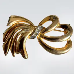 #01 Gloria Vanderbilt Gold Tone Bow Brooch With White Rhinestones