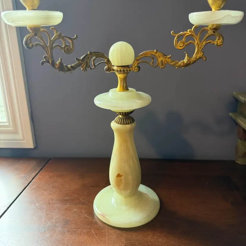 A vintage alabaster and brass candelabra with ornate metal arms. 13.5” Tall