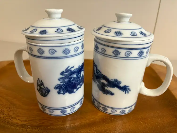 A Set Of Two Chinese Tea Mugs With Tea Strainers And Lids