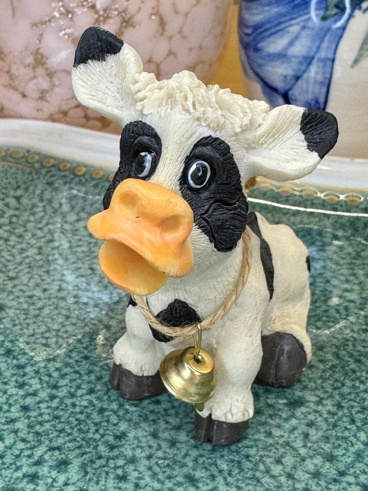 Mini whimsical resin figurine of a cow