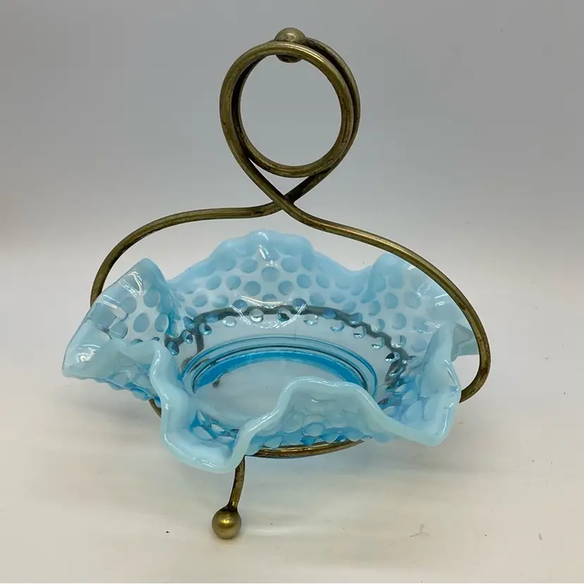 #0232 Fenton blue hobnail glass candy dish with ruffled rim in brass stand.