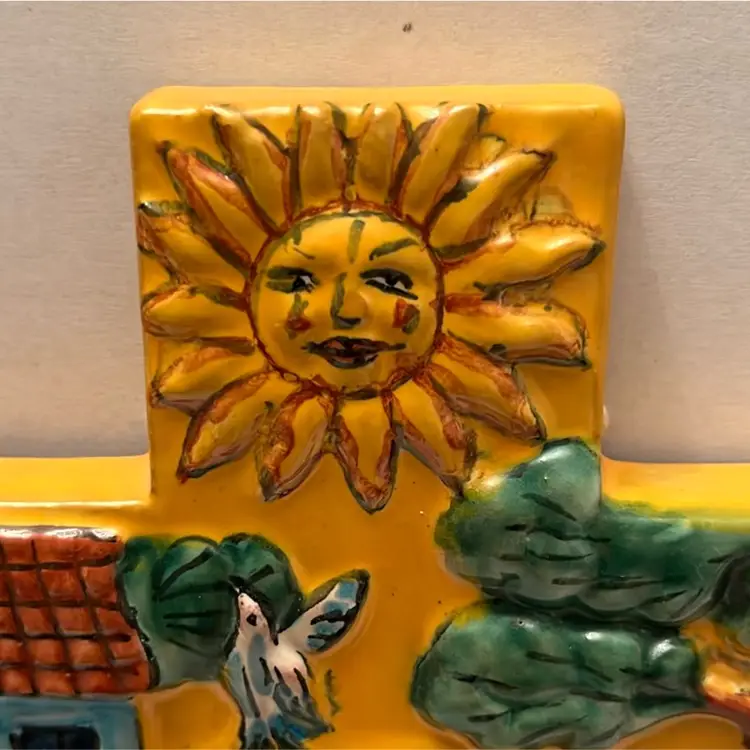 Yellow made in Mexico Designed Cross. It has drawn raised scenes of Mexican Land and culture,