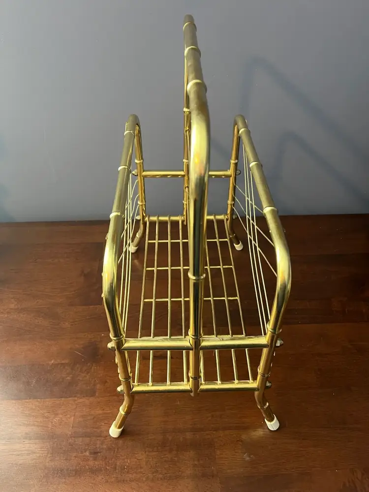 A brass faux bamboo tiered magazine rack with wire shelving.
17 inches tall 14 inches wide 7 inches deep