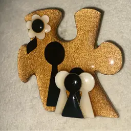Lucinda ‘People Pin’ - Beautiful Gold Puzzle Shape With A Family Of FIVE (1 Parent And 4 Children).  Includes A Cream And Black Flower. People Are Black And Cream Colored.  Autism Awareness