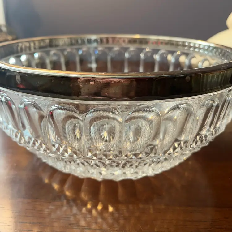 silver-plated rim cut glass serving bowl. 9” Circa 1950-1970s 
Does Have Some Patina Around Silver Rim Pictured .