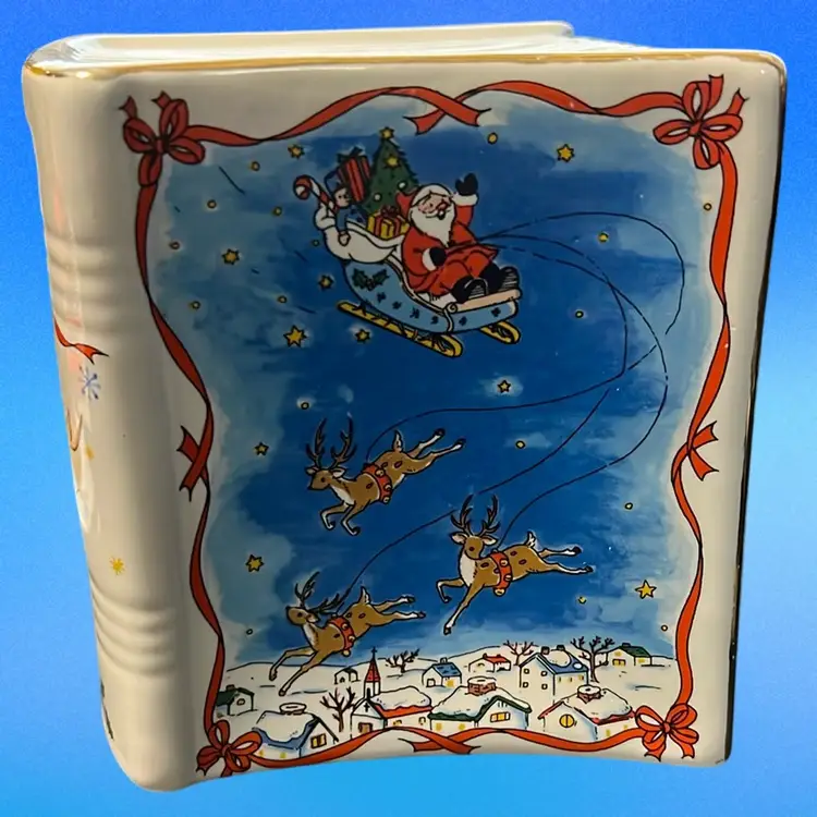 Studio Nova ceramic 'Santa's Story' book bank with a Christmas theme. 3” Tall. Excellent Condition, Great Christmas Gift Idea!