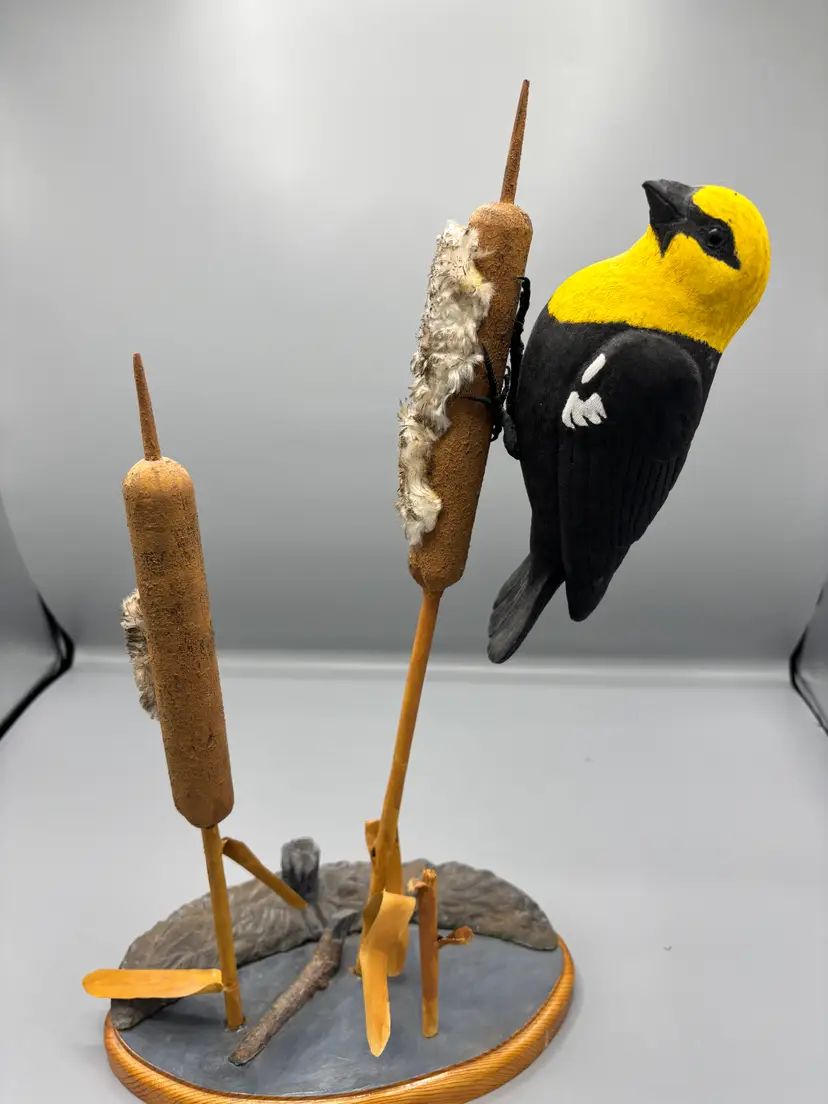 Yellow headed black bird wood carving