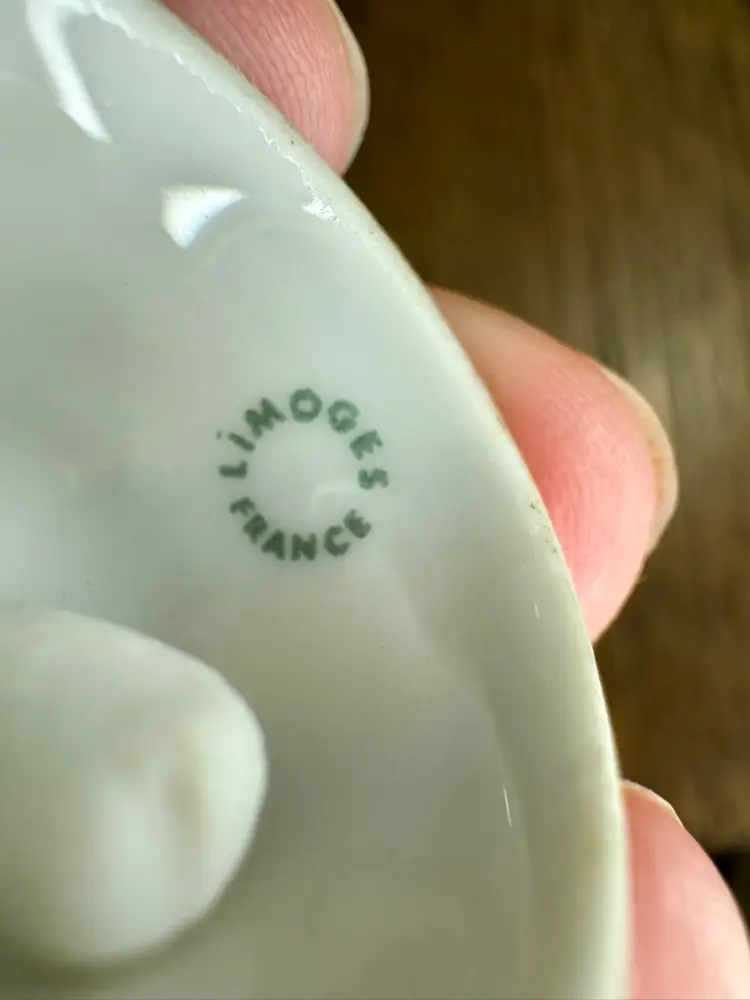 Vintage mini porcelain bell, Limoges, France, featuring gold trim and a painted scene of a couple. 1” tall