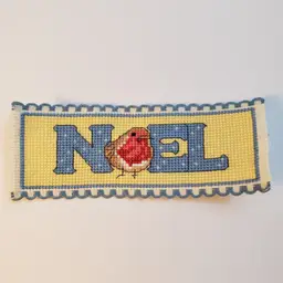 New Cross-stitched bookmark Christmas themed "Noel" on Ribband with blue trim.