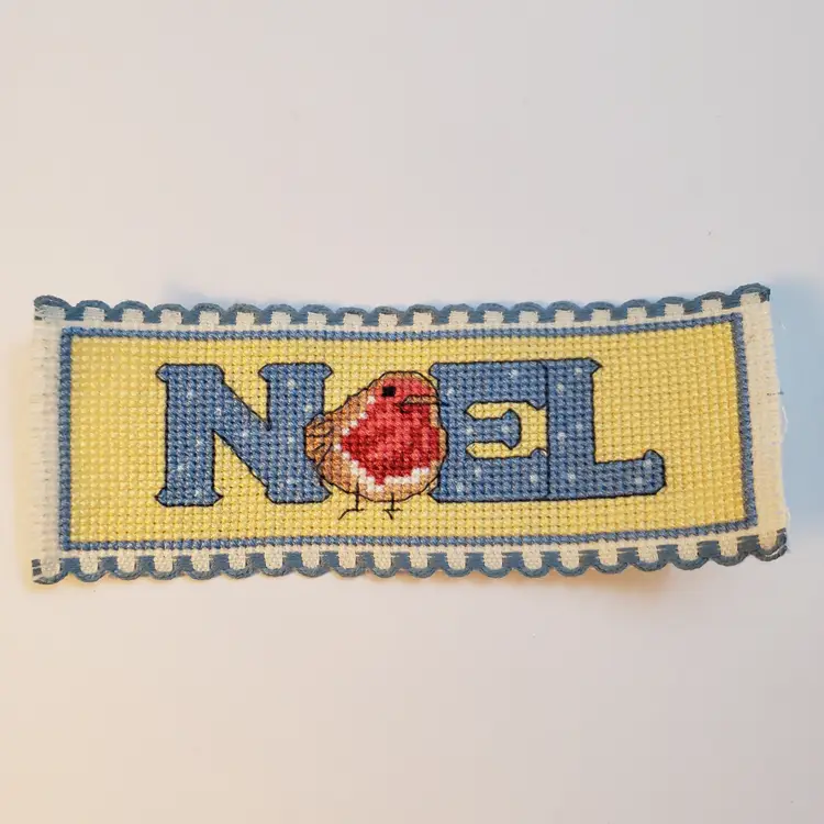 New Cross-stitched bookmark Christmas themed "Noel" on Ribband with blue trim.