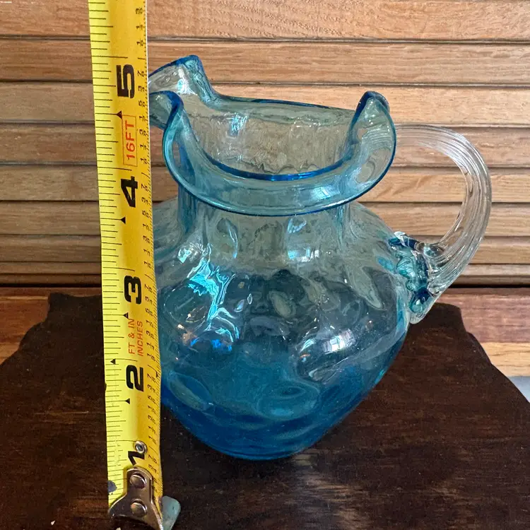 Hand blown glass turquoise pitcher as is, appears to be crack but not felt on outside