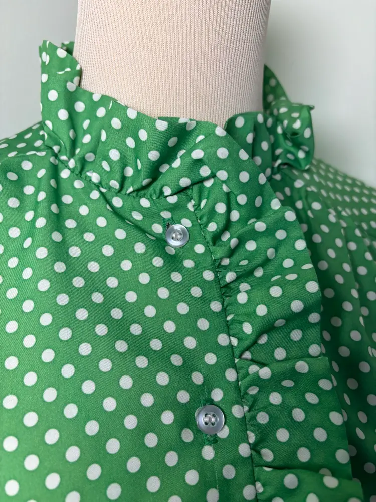 Adorable 1970s green polka dot blouse with ruffle collar 