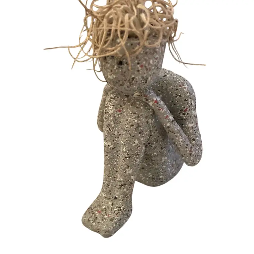 Figurine Of A Man Resting His Head On His Knees