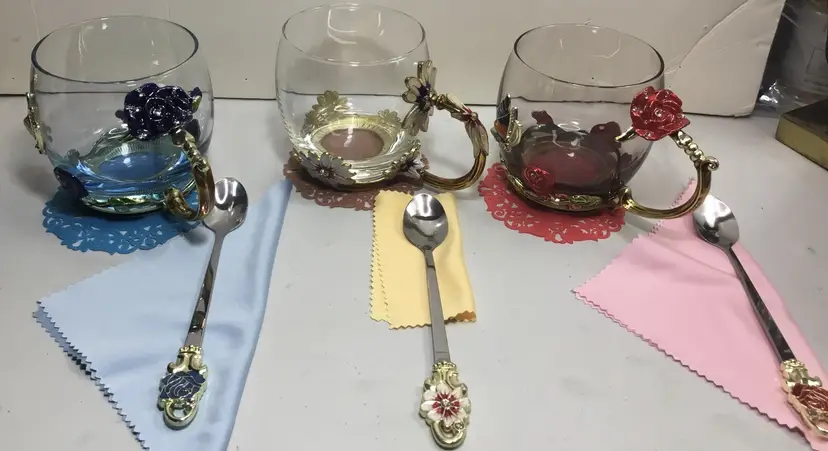 Set of 3, glass and enamel coffee/tea cups, includes spoons, doilies, polishers