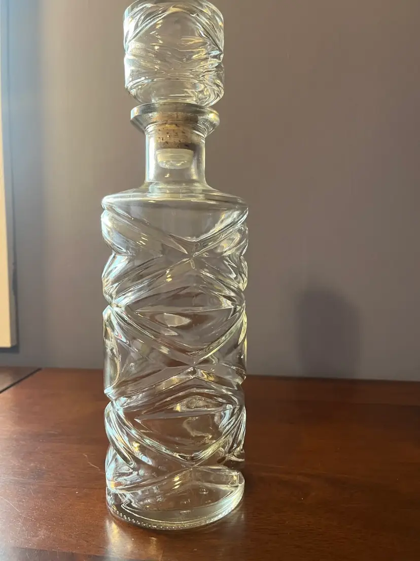A clear glass mid-century modern liquor decanter with a diamond pattern With Stopper . 11” Tall
