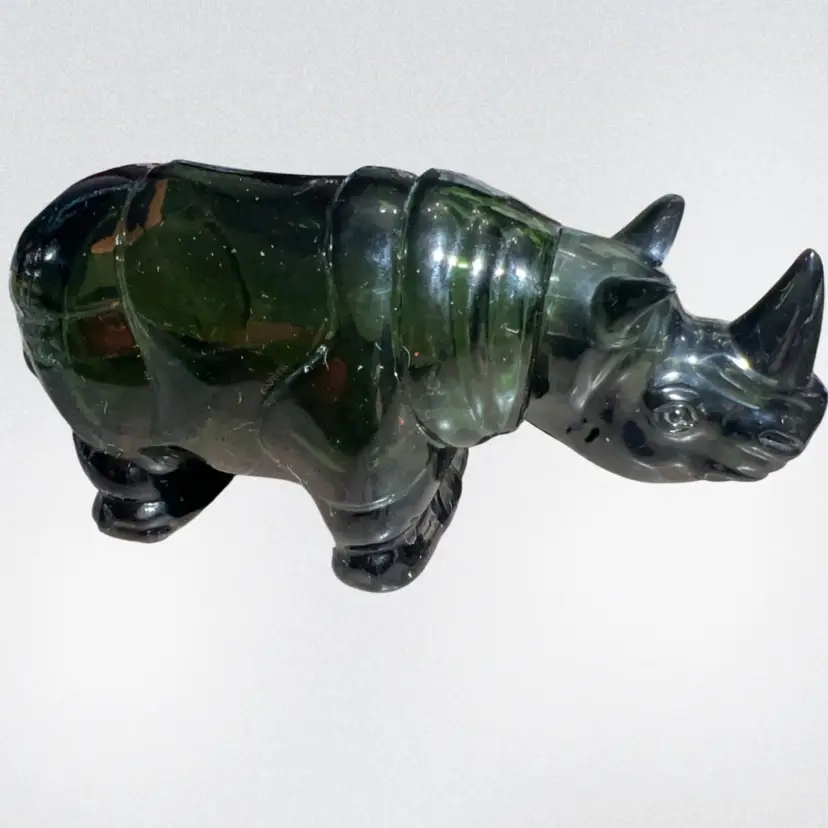 This is a vintage Avon green glass rhinoceros animal Perfume decanter.