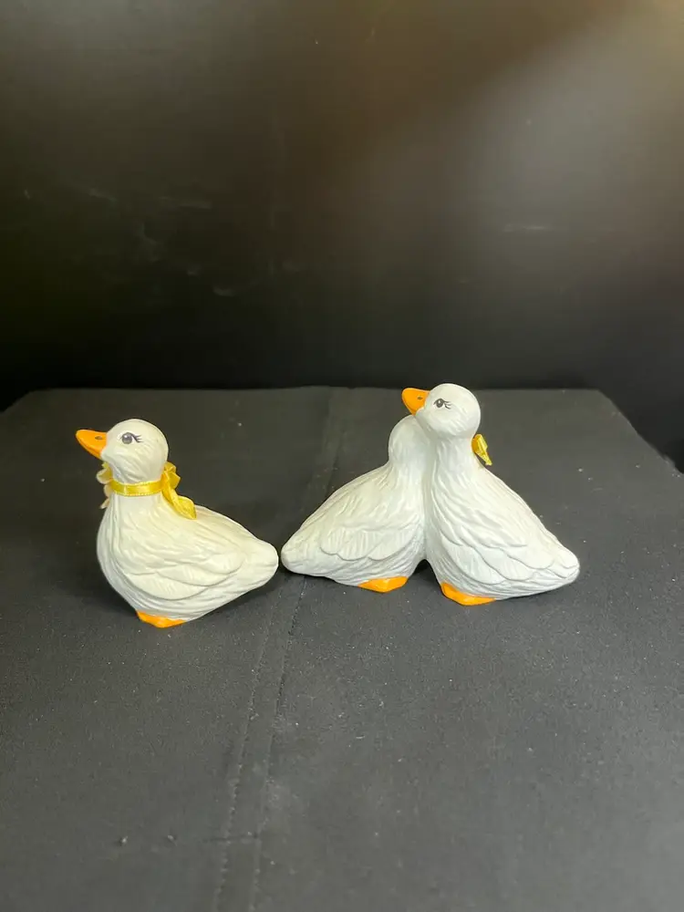 Vintage Hobbiest "Smalls" Ceramic Geese. One is a Cute Couple-Complete w/ Bow Around One Neck, & Dried Flowers Around the Other. The Other Figurine is a Goose by Itself w/ Yellow Ribbon & Dried Flowers-Lot 60