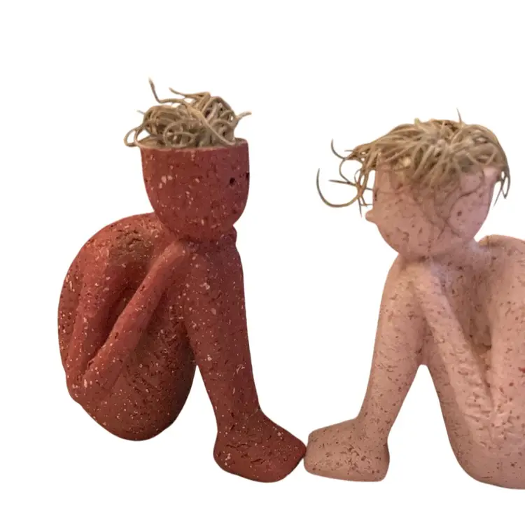 Two Figurines Of A Boy/Man Resting Head On Knees