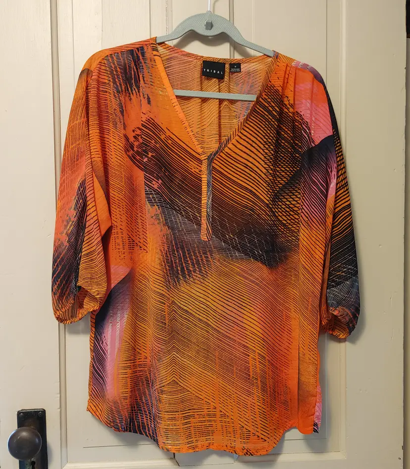 Top- Tribal brand. Size medium. 100% polyester. Sheer orange fabric with navy. No callouts.