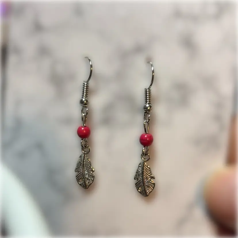 Silver Dangle Earrings With A Red Bead And Feathers