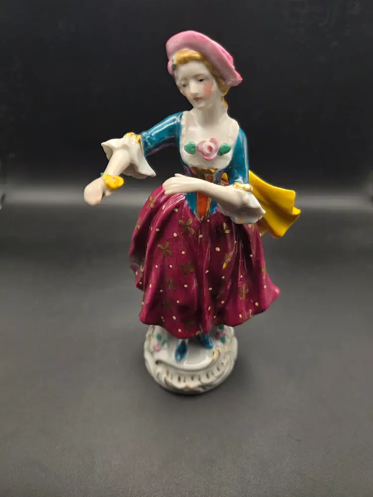 Girl holding flower figurine