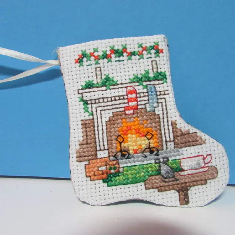 completed handmade cross stitch small Christmas stocking ornament fireplace