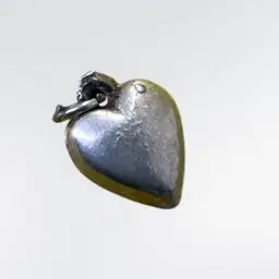 #33 Sterling Puffy Heart Charm .5”