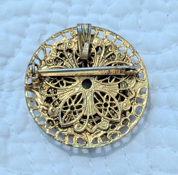 Vintage Circular Gold Tone Brooch with Reverse Carved Rose Surrounded by Black Rhinestones