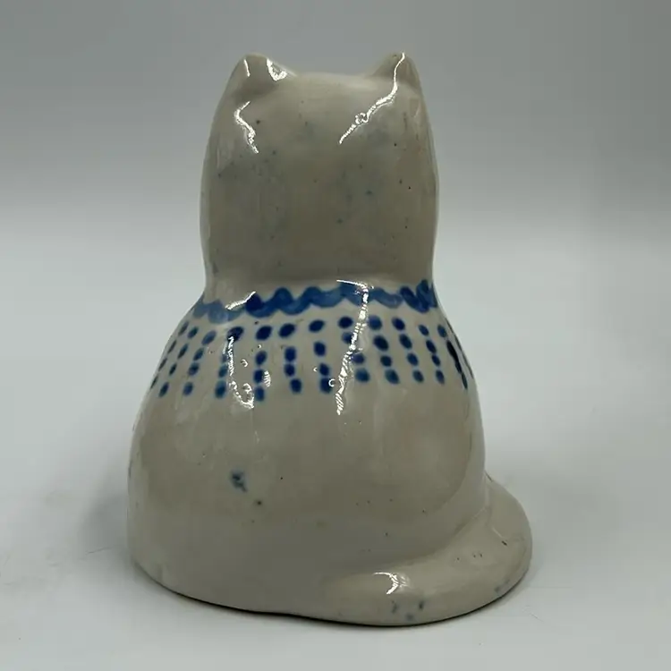 Vintage Folk Art MA Hadley Pottery Cat With Blue Bow And Markings. Looks Like A Glaze Skip On One Of The Feet See Photos.  4.5” T. 3.5” W. Signed On The Inside.