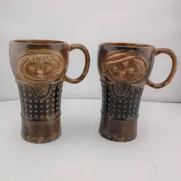 Pair of Holt Howard stoneware face mugs
