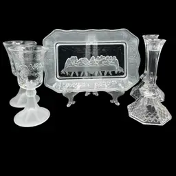 Vignette #9 Includes A Clear Pressed Glass Plate Depicting The Last Supper, A Pair Of Matching Water/Wine Goblets With Frosted Stem, And A Pair Of Clear Glass Candlestick’s