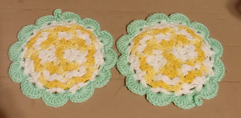2 crochet hot pads- green yellow white. 8.5 inch diameter.
