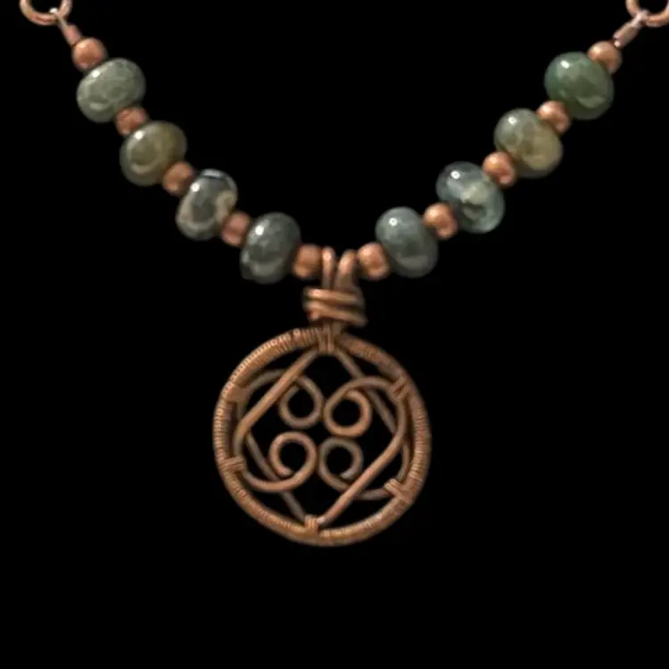 Handmade copper wire-wrapped Love Knot pendant necklace with moss agate beads.